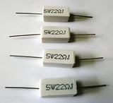 22 Ohm 5W - four rectangular white ceramic cement resistors with axial wire leads arranged in a vertical column against a white background.