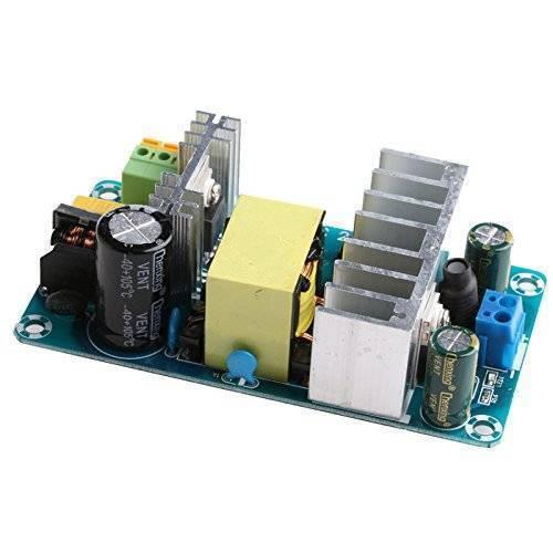220VAC-24VDC Switching Power Supply Board - a green circuit board with two silver heatsinks, a yellow transformer, black capacitors, and connectors.