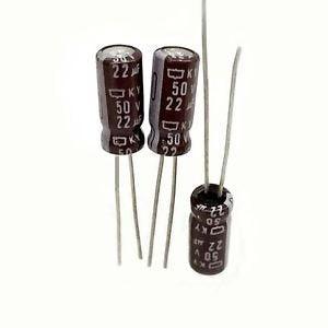 22uF 50V Electrolytic Capacitor - three brown radial electrolytic capacitors with silver leads against a white background.