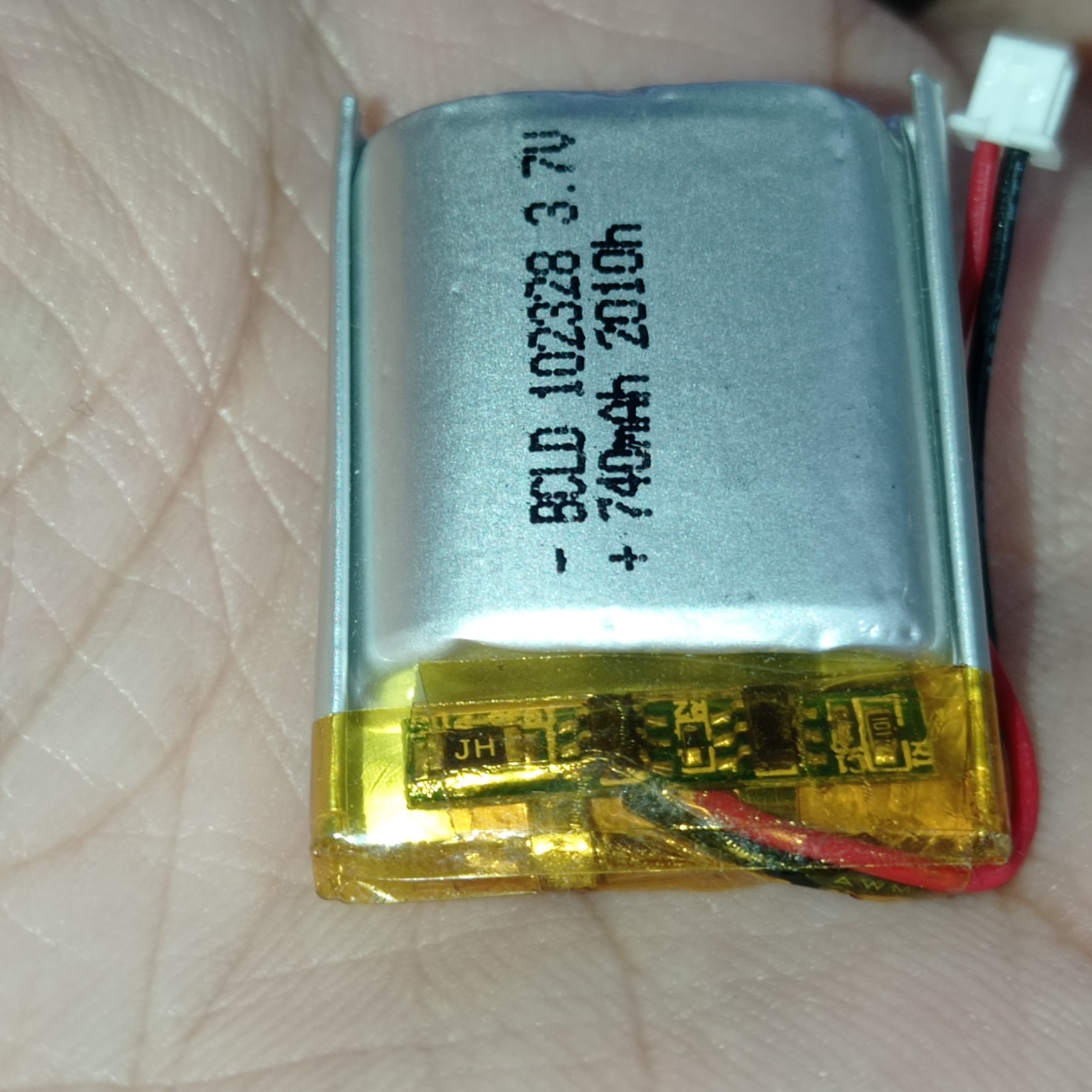 23mm x 28mm x 10mm 3.7V 740mA Li Ion Battery - a silver rectangular lithium-ion battery with a yellow protective tape, red and black wires, and a connector.