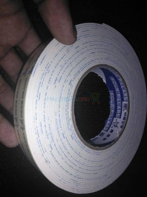 24mm Double Sided Adhesive Tape - a roll of white foam tape with blue printed branding on the side and a central paper core.