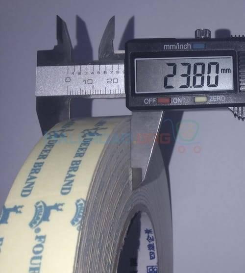 24mm Double Sided Adhesive Tape - shown in a close-up measurement, with a digital caliper displaying 23.80mm across the width of the tape roll.
