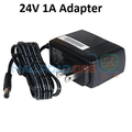 24V 1A DC Power Supply Adapter 2.1mm x 5.5mm Plug Used - a black wall-plug power supply with a coiled cable and a barrel connector.