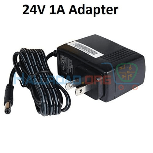 24V 1A DC Power Supply Adapter 2.1mm x 5.5mm Plug Used - a black wall-plug power supply with a coiled cable and a barrel connector.
