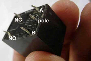 24V Coil T73 Relay 10 Amp Spdt 5 Pin Relay - a close-up of the black rectangular base showing five metal pins labeled A, B, pole, NC, and NO.