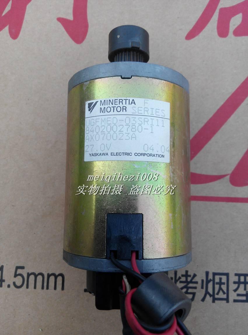 24V Japan Yaskawa Servo DC Motor With Encoder Ugfmed-03SRI11 0V To 27V Maximum - a cylindrical gold-toned metal unit with a top gear shaft and a bottom black connector with wires.