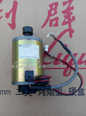 24V Japan Yaskawa Servo DC Motor With Encoder Ugfmed-03SRI11 0V To 27V Maximum - cylindrical gold-toned body, a black gear shaft, and two attached white electrical connectors.