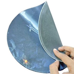 250MMX250MM Mouse Pad - shown being held and folded to reveal its dark, textured rubberized underside and a printed top surface featuring a glowing light.