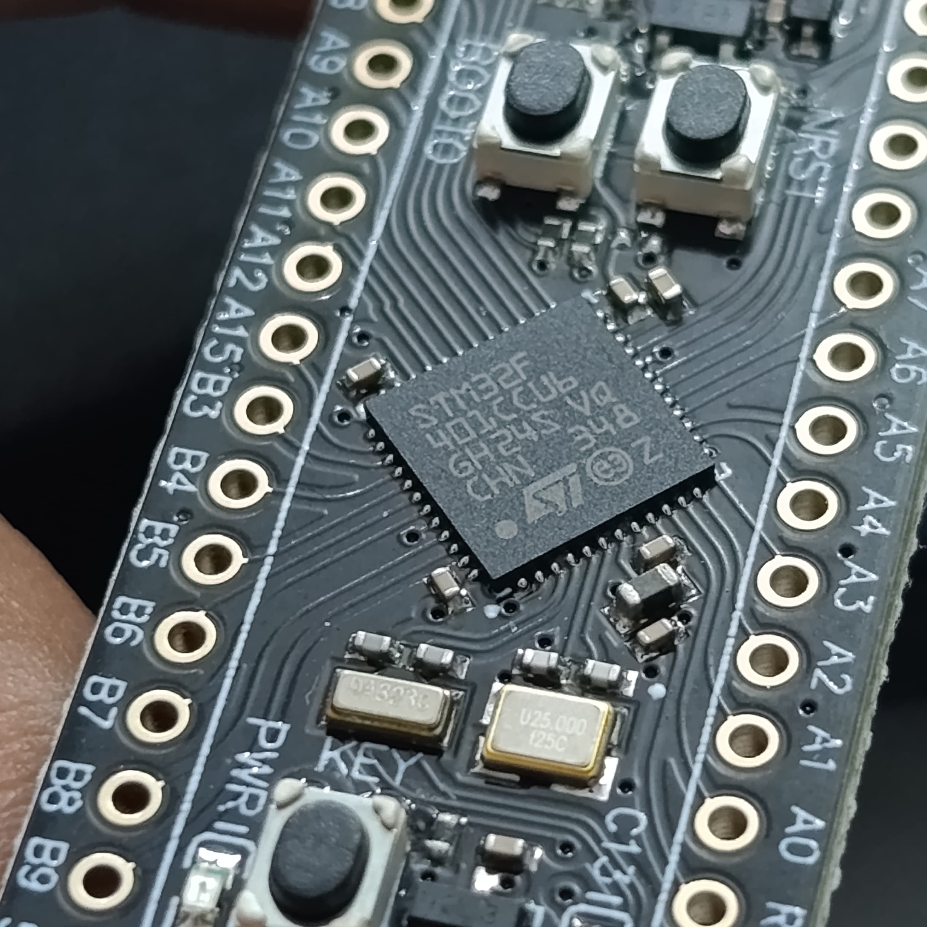 256KB ROM Back Pill Development Board STM32F401 STM32F401CCU6 IC V3.0 - a close-up showing the STM32F401CCU6 IC, two push buttons, and a crystal oscillator on a black circuit board.
