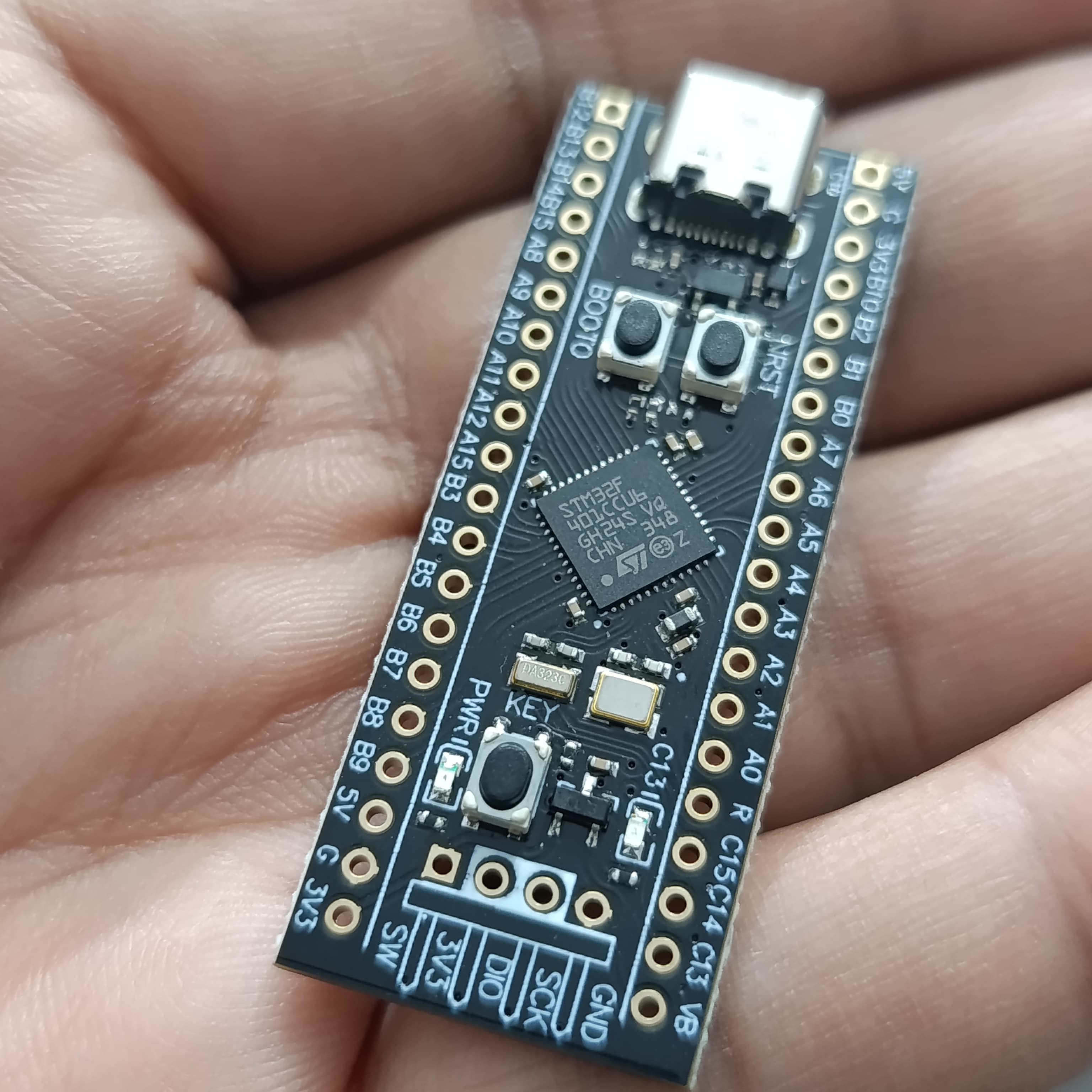 256KB ROM Back Pill Development Board STM32F401 STM32F401CCU6 IC V3.0 - shown held in a hand, featuring a black PCB, USB-C port, two buttons, and labeled pin headers.