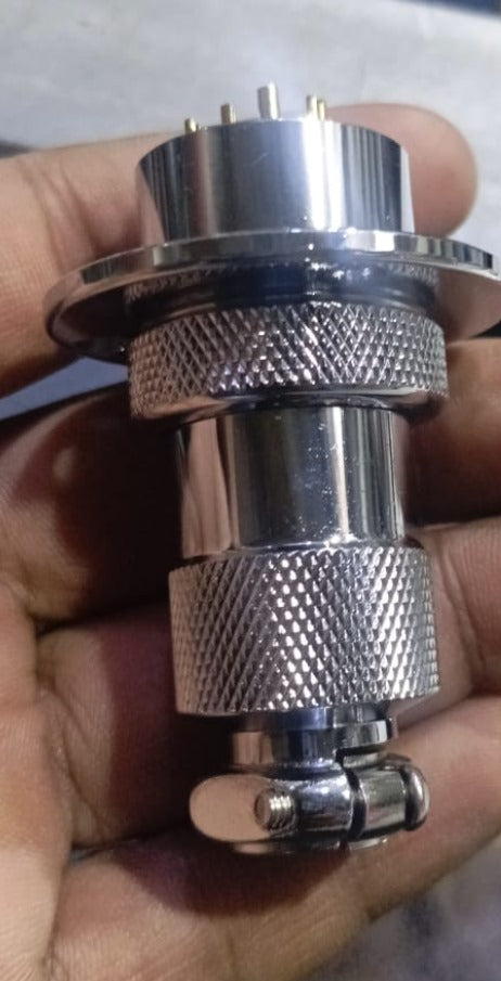 25mm 12 Pin Connector - a close-up showing a cylindrical chrome-plated metal connector held in a hand with a cable clamp at the base.