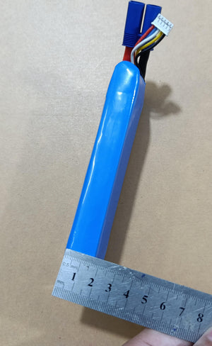 25S 4S 14.8V 2200mAh LiPo Battery - shown in a blue rectangular casing with a metal ruler measuring its width alongside a blue connector and white balance plug.