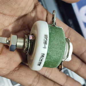 25W 1k Ohm High Power Wire Wound Potentiometer, Rheostat, Variable Resistor - shown as a close-up of a green cylindrical component with a metal shaft and mounting nut held in a hand.