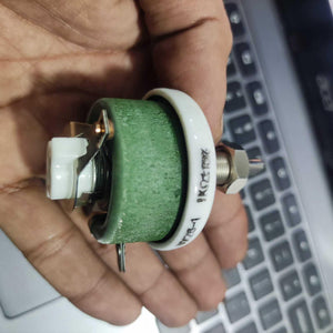 25W 1k Ohm High Power Wire Wound Potentiometer, Rheostat, Variable Resistor - shown as a close-up of a green cylindrical ceramic resistor held in a hand, featuring a metal adjustment shaft.