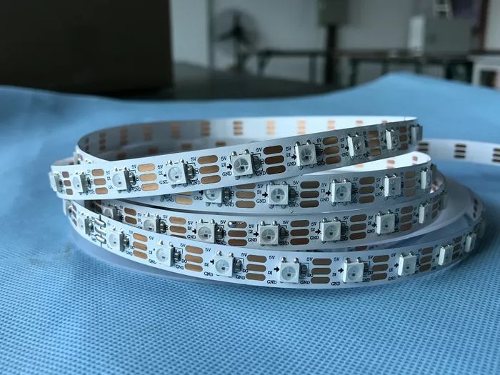 2812 LED Strip - shown as a coiled white flexible circuit board with multiple surface-mounted LEDs, copper contact pads, and 5V, DI, DO, and GND labels.
