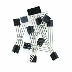 2N2222A Bipolar Junction NPN Transistor - shown as a small pile of black plastic three-pin electronic components with silver metal leads.