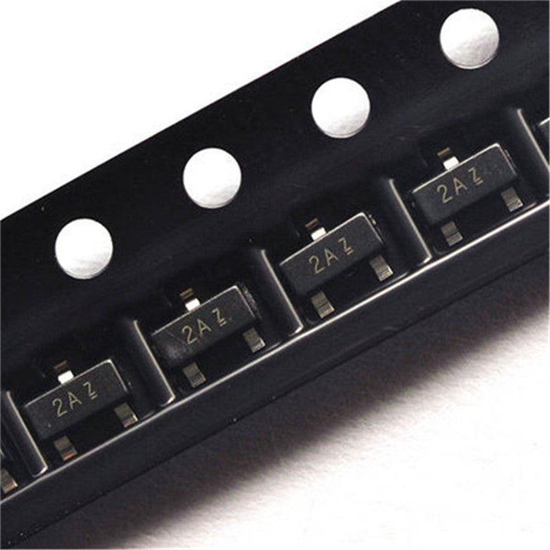 2N3906 MMBT3906 Transistor PNP SMD Sot-23 - shown in a close-up view of multiple black components arranged in a plastic carrier tape.