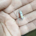 2W 250 Ohm Resistor - shown as a close-up of a cylindrical electronic component with black, yellow, and red color bands held in a person's hand.