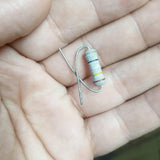 2W 250 Ohm Resistor - shown as a close-up of a cylindrical electronic component with black, yellow, and red color bands held in a person's hand.