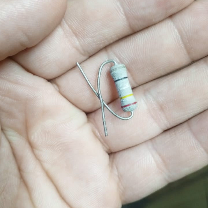 2W 250 Ohm Resistor - shown as a close-up of a cylindrical electronic component with black, yellow, and red color bands held in a person's hand.