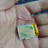 3.7V 100mAh Lithium-ion Polymer Battery - High Energy, Compact Power Source - a small rectangular silver battery with a yellow adhesive backing and a two-wire connector, held in a palm.