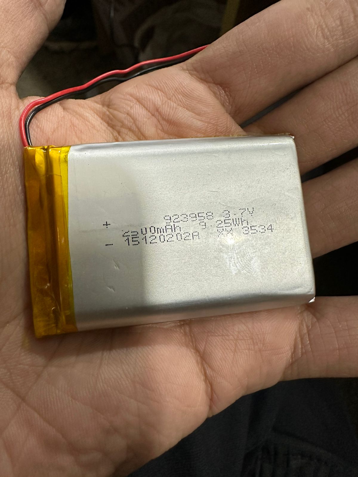 3.7V 2500mAh Lithium-Ion Rechargeable Battery - Li-Po Battery Pack - a rectangular silver Li-Po battery pack held in a hand, featuring red and black wires.