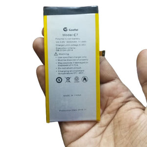 3.7V 3000mAh Polymer Li-ion Battery 47x97x3.5mm - a rectangular silver and yellow battery held in a hand, showing the Cootel Model C7 label and a small connector.