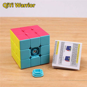 3 By 3 Rubik Cube 3x3 - with pink, yellow, and blue panels, featuring a detached center cap and an instructional paper guide on a wooden surface.