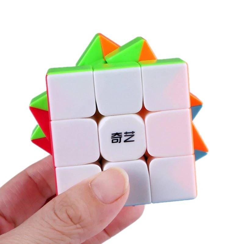 3 By 3 Rubik Cube 3x3 - held in a hand, showing a white-faced cube with Chinese characters in the center and visible green, orange, red, and blue sides.