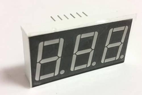 3 Digit 7 Segment Common Anode Red Color Display - shown as a white rectangular electronic component with three unlit seven-segment digits on a black face.