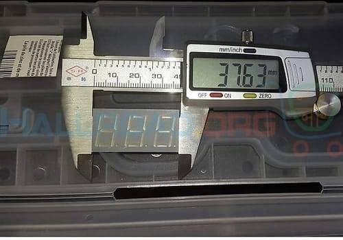 3 Digit 7 Segment Common Anode Red Color Display - being measured by a digital caliper showing a reading of 37.63 mm.