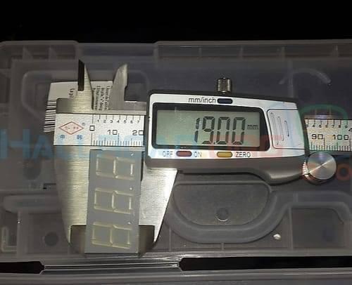 3 Digit 7 Segment Common Anode Red Color Display - shown being measured with digital calipers displaying 19.00 mm inside a plastic storage case.