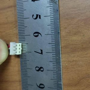 3 Pin Connector With 6 Inch Length Wire 2mm pitch 2mm distance between 2 pins - shown in a close-up view being measured against a metal ruler to display its 2mm pitch.