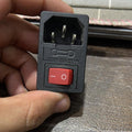 3-pin Male AC Power Inlet Socket With Indicator - close-up of the black plastic rectangular module featuring a red rocker switch and a fuse compartment.