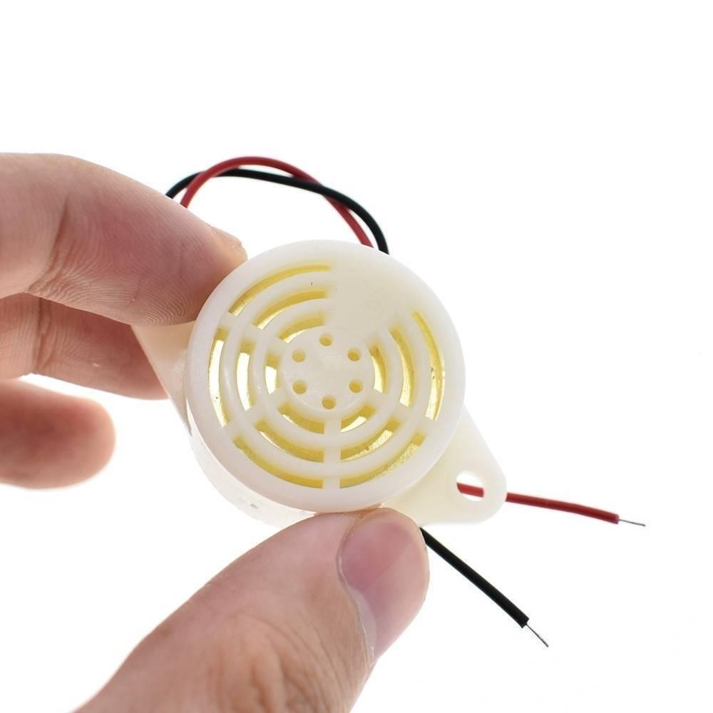 3 To 24V Electronic Buzzer Beep Alarm Sfm-27 - a round white plastic housing with a speaker grille and two attached wires.