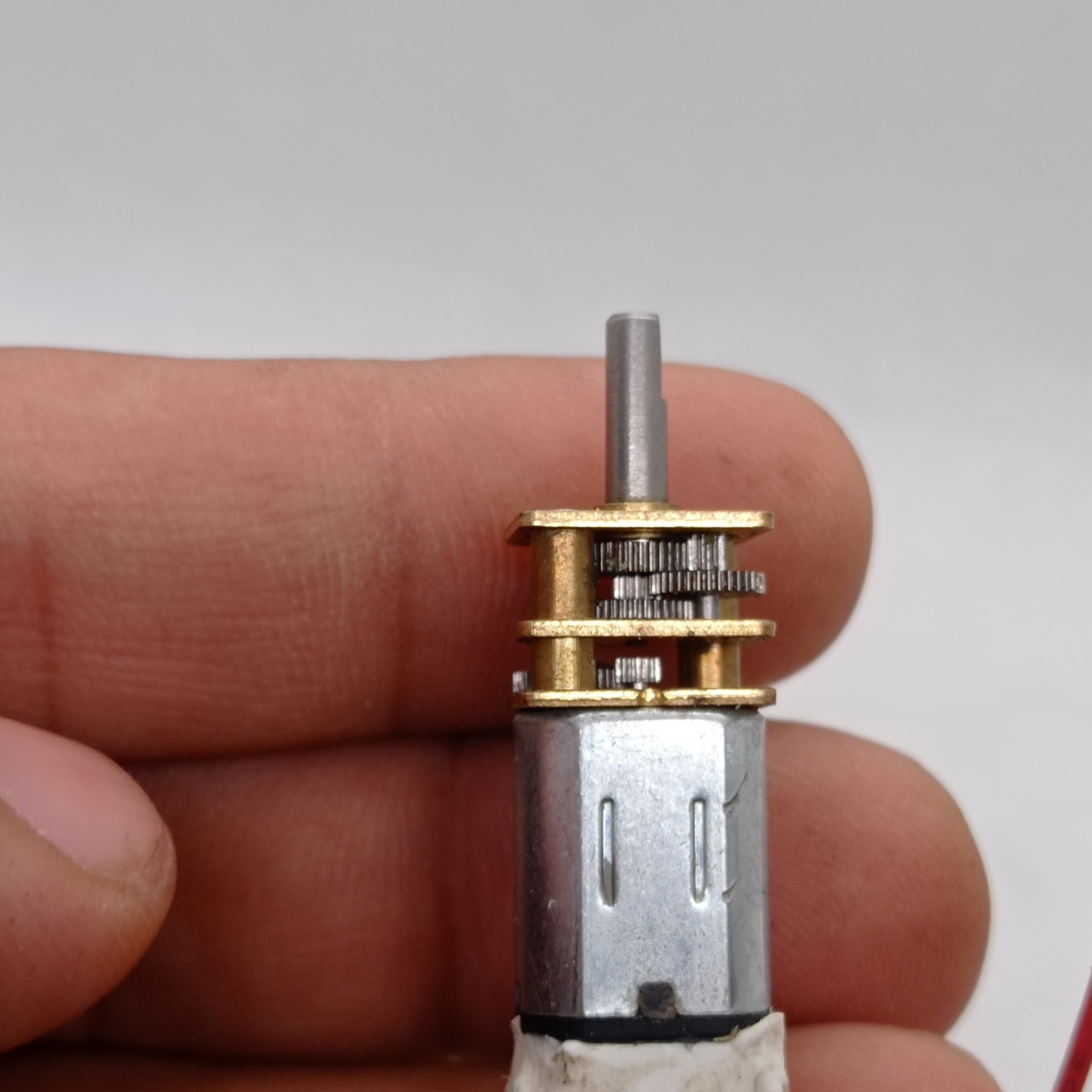 300RPM N20 DC Gear Motor The Perfect Low RPM High Torque Motor For Your Electronics Projects - the silver metal motor body attached to a brass-colored gearbox with exposed internal gears and a drive shaft.