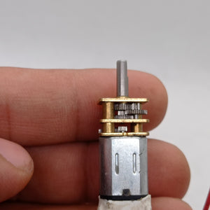 300RPM N20 DC Gear Motor The Perfect Low RPM High Torque Motor For Your Electronics Projects - the silver metal motor body attached to a brass-colored gearbox with exposed internal gears and a drive shaft.