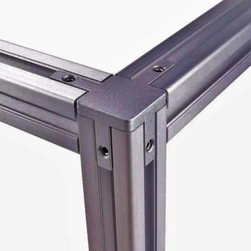 3030 Size 3 Way End Corner Bracket Connector For t Slot Aluminum Extrusion Profile 3030 - a close-up of a grey metal corner piece connecting three lengths of t-slot aluminum extrusion profiles.