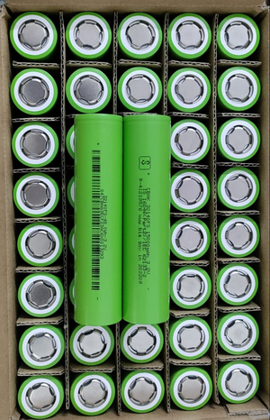 32140 3.2V 15A LiFePO4 Cell - shown as a bulk pack of green cylindrical batteries, with two units placed horizontally across the top of the cardboard box.