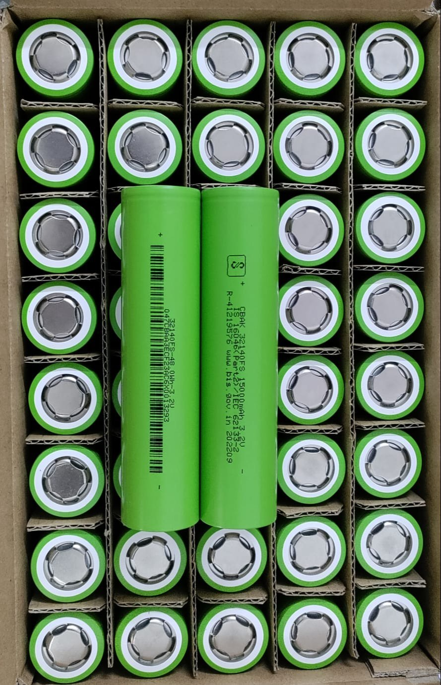 32140 3.2V 15A LiFePO4 Cell - shown as a bulk pack of green cylindrical batteries, with two units placed horizontally across the top of the cardboard box.