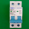 32A Tomzn Tob7z-63 2p DC 1000V Solar Circuit Breaker - Reliable Protection For Solar System - a white two-pole electrical switch with blue toggles, terminal screws, and printed technical specifications.