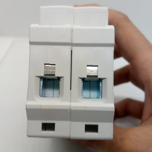 32A Tomzn Tob7z-63 2p DC 1000V Solar Circuit Breaker - Reliable Protection For Solar System - a close-up showing the two white modular units with silver-colored wire terminal ports.