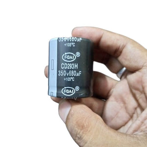 350V 680uF Capacitor - held in a hand, showing a black cylindrical body with the FOAI brand, CD293H model, and 350V 680uF +105°C specifications printed.