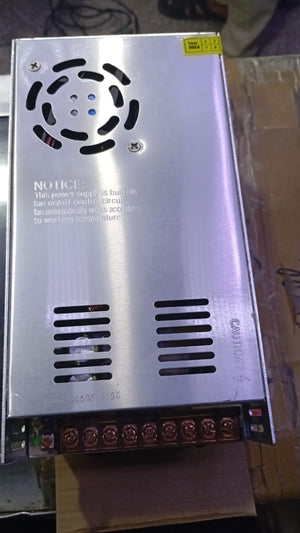 36V 10A Power Supply - shown as a rectangular silver metal unit with a cooling fan, ventilation slots, and a terminal block for electrical connections.