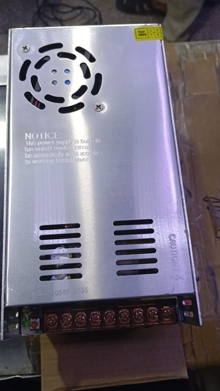 36V 10A Power Supply - shown as a rectangular silver metal unit with a cooling fan, ventilation slots, and a terminal block for electrical connections.