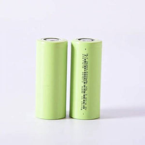 3c Discharge Hly Ncm 26650 5Ah 5000mAh Lithium Ion Battery Cell For E-bike Battery Pack - two cylindrical light green batteries standing upright, one showing printed technical specifications and a barcode.