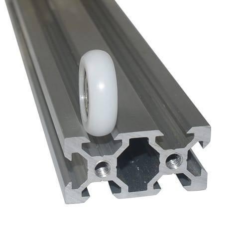 3d Printer Track Roller Nylon Plastic Bearing Pulley - shown as a white plastic wheel resting on a section of silver aluminum extrusion profile.