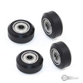 3dinnovations Openbuilds Pom Plastic Wheel Mini V With 105ZZ Bearing - four black V-slot wheels with silver metal ball bearings arranged on white.