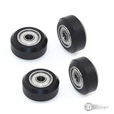 3dinnovations Openbuilds Pom Plastic Wheel Mini V With 105ZZ Bearing - four black V-slot wheels with silver metal ball bearings arranged on white.