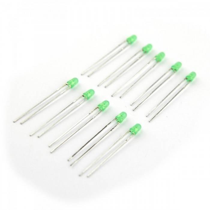 3mm Green LED - a collection of nine small green light-emitting diodes with two metal pins each, arranged on a white background.